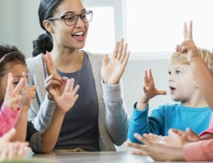 Group of kindergarten kids friends holding hands playing at park